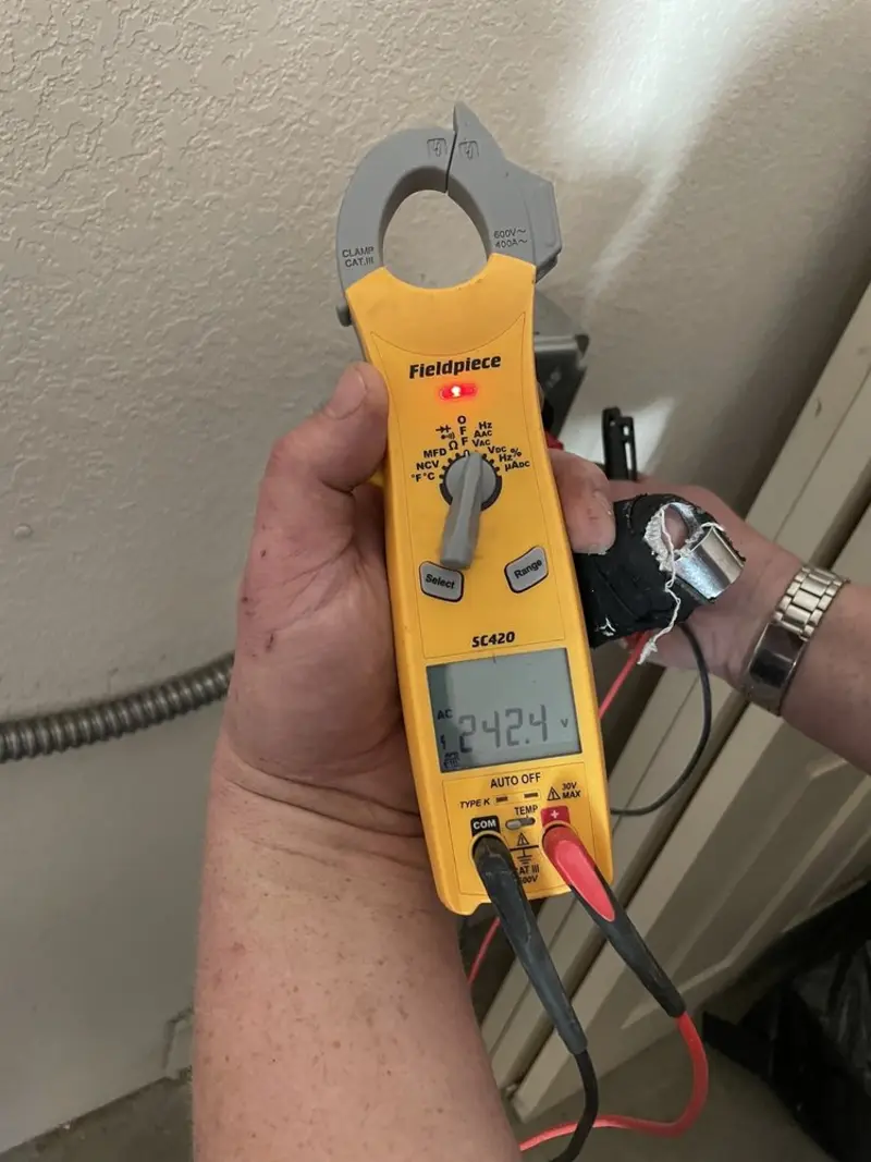 Voltage testing with clamp meter during Ceiling Fan Installation in Lakeland